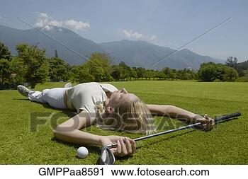 Stock Photography - woman laying on 
golf course with 
golf club and 
golf ball. fotosearch 
- search stock 
photos, pictures, 
images, and photo 
clipart