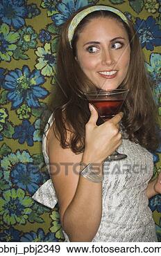 Stock Photograph - young woman in 
retro outfit holding 
cocktail. fotosearch 
- search stock 
photos, pictures, 
images, and photo 
clipart