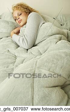 Picture - young woman sleeping 
in bed. fotosearch 
- search stock 
photos, pictures, 
images, and photo 
clipart