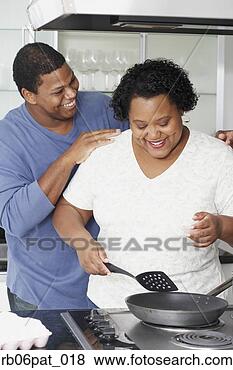 Stock Photo - african couple 
cooking in kitchen. 
fotosearch - search 
stock photos, 
pictures, images, 
and photo clipart