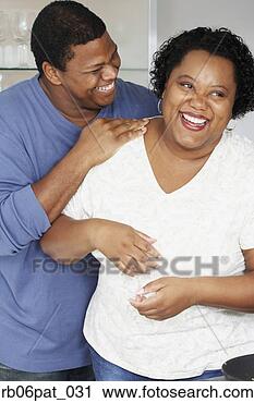 Stock Photography - african couple 
hugging and laughing. 
fotosearch - search 
stock photos, 
pictures, images, 
and photo clipart