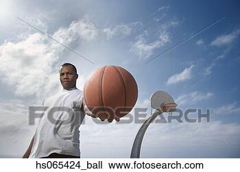 Stock Photo - african man holding 
basketball. fotosearch 
- search stock 
photos, pictures, 
images, and photo 
clipart