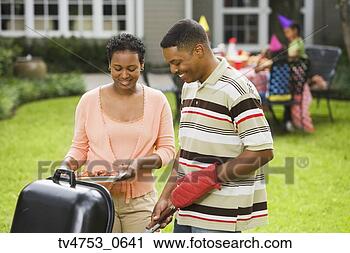 Stock Photography - african parents 
barbequing for 
child’s birthday. 
fotosearch - search 
stock photos, 
pictures, images, 
and photo clipart