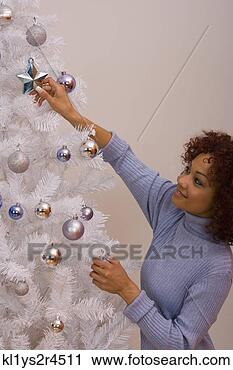 Stock Photography - african woman 
hanging christmas 
ornament. fotosearch 
- search stock 
photos, pictures, 
images, and photo 
clipart