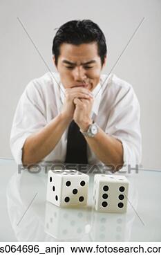 Stock Photo - asian man looking 
at dice. fotosearch 
- search stock 
photos, pictures, 
images, and photo 
clipart