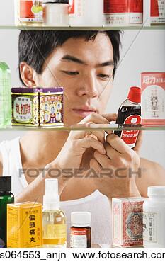 Stock Photo - asian man reading 
chinese medicine 
label. fotosearch 
- search stock 
photos, pictures, 
images, and photo 
clipart