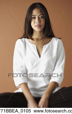 Stock Image - asian woman sitting 
cross legged. 
fotosearch - search 
stock photos, 
pictures, images, 
and photo clipart