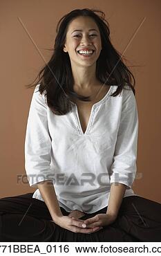 Stock Photo - asian woman sitting 
cross legged. 
fotosearch - search 
stock photos, 
pictures, images, 
and photo clipart