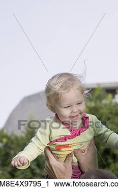 Stock Photography - baby being held 
up outdoors. fotosearch 
- search stock 
photos, pictures, 
images, and photo 
clipart