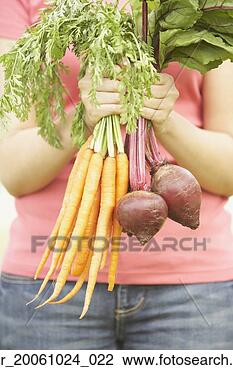 Stock Photo - close up of hispanic 
woman holding 
fresh vegetables. 
fotosearch - search 
stock photos, 
pictures, images, 
and photo clipart