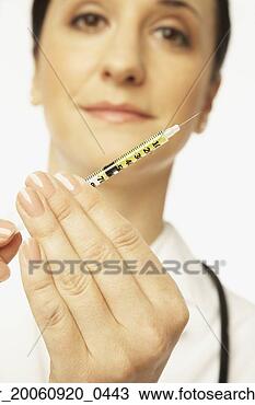 Stock Photo - hispanic female 
doctor holding 
syringe. fotosearch 
- search stock 
photos, pictures, 
images, and photo 
clipart
