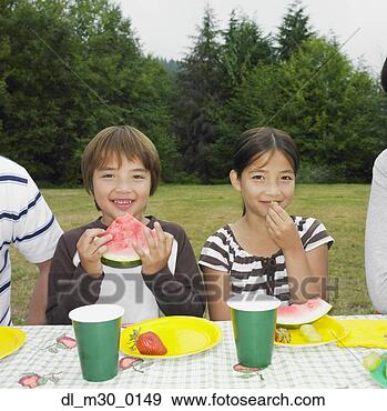 Stock Photograph - mixed race brother 
and sister eating 
watermelon. fotosearch 
- search stock 
photos, pictures, 
images, and photo 
clipart