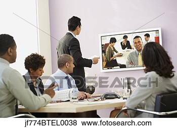 Stock Photo - multi-ethnic businesspeople 
having video conference. 
fotosearch - search 
stock photos, 
pictures, images, 
and photo clipart