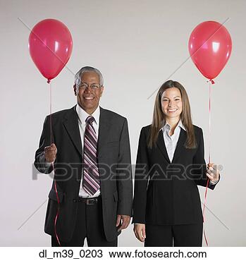 Stock Photo - multi-ethnic businesspeople 
holding balloons. 
fotosearch - search 
stock photos, 
pictures, images, 
and photo clipart