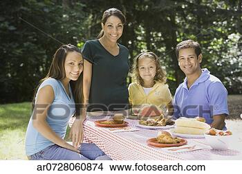 Stock Photo - portrait of hispanic 
family at picnic 
table. fotosearch 
- search stock 
photos, pictures, 
images, and photo 
clipart