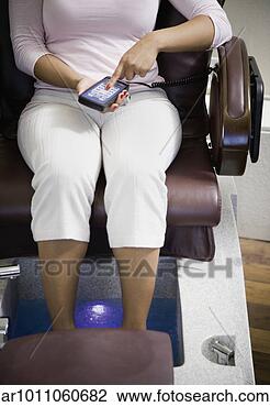 Stock Photo - woman adjusting 
seat in pedicure 
chair. fotosearch 
- search stock 
photos, pictures, 
images, and photo 
clipart