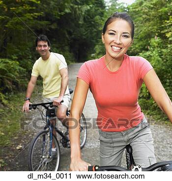 Stock Photography - couple riding 
bicycles on nature 
trail. fotosearch 
- search stock 
photos, pictures, 
images, and photo 
clipart