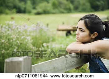 Stock Photo - girl leaning on 
wooden fence. 
fotosearch - search 
stock photos, 
pictures, images, 
and photo clipart