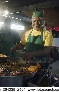 Stock Photo - hispanic man cooking 
at taco stand. 
fotosearch - search 
stock photos, 
pictures, images, 
and photo clipart