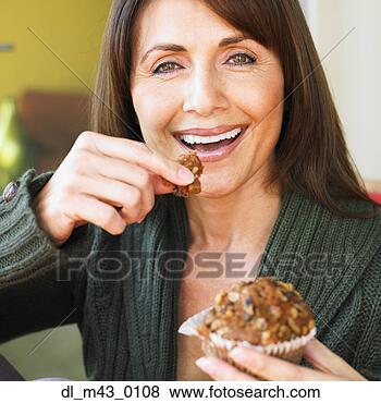 Stock Photo - hispanic woman 
eating muffin. 
fotosearch - search 
stock photos, 
pictures, images, 
and photo clipart