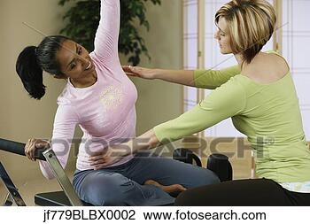 Stock Photo - indian woman exercising 
with personal 
trainer. fotosearch 
- search stock 
photos, pictures, 
images, and photo 
clipart