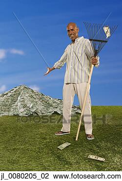 Stock Photo - man raking large 
pile of dollar 
bills. fotosearch 
- search stock 
photos, pictures, 
images, and photo 
clipart