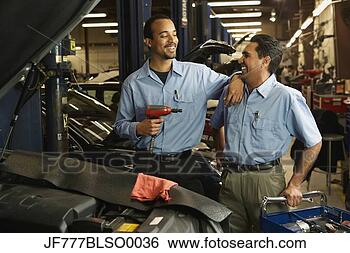 Stock Photo - multi-ethnic male 
auto mechanics 
in shop. fotosearch 
- search stock 
photos, pictures, 
images, and photo 
clipart