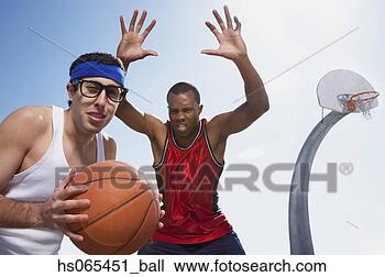 Stock Photo - nerdy man playing 
basketball with 
athlete. fotosearch 
- search stock 
photos, pictures, 
images, and photo 
clipart