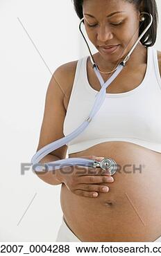 Stock Photo - pregnant african 
woman holding 
stethoscope on 
stomach. fotosearch 
- search stock 
photos, pictures, 
images, and photo 
clipart