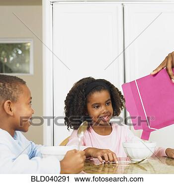 Stock Photography - african american 
brother and sister 
having breakfast. 
fotosearch - search 
stock photos, 
pictures, images, 
and photo clipart