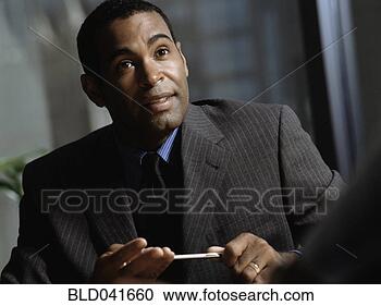 Stock Photography - african american 
businessman holding 
pen. fotosearch 
- search stock 
photos, pictures, 
images, and photo 
clipart