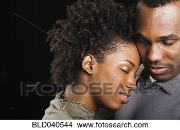 Stock Photo - african american 
couple hugging 
with eyes closed. 
fotosearch - search 
stock photos, 
pictures, images, 
and photo clipart