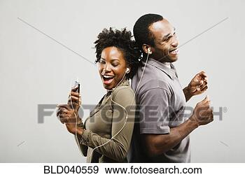 Stock Photograph - african american 
couple listening 
to same mp3 player. 
fotosearch - search 
stock photos, 
pictures, images, 
and photo clipart