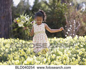 Stock Photo - african american 
girl in field 
of spring flowers. 
fotosearch - search 
stock photos, 
pictures, images, 
and photo clipart