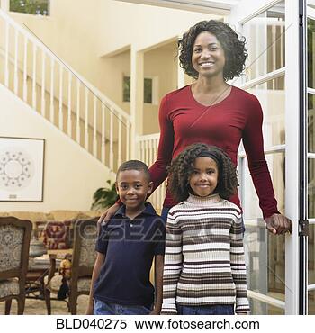 Stock Image - african american 
mother and children 
in doorway. fotosearch 
- search stock 
photos, pictures, 
images, and photo 
clipart