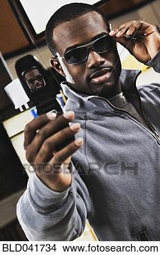 Stock Photo - african man shopping 
for sunglasses. 
fotosearch - search 
stock photos, 
pictures, images, 
and photo clipart