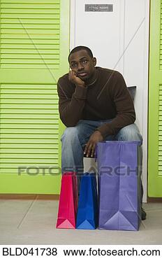 Stock Photo - african man waiting 
outside dressing 
rooms. fotosearch 
- search stock 
photos, pictures, 
images, and photo 
clipart