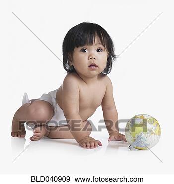 Stock Photograph - asian baby next 
to globe. fotosearch 
- search stock 
photos, pictures, 
images, and photo 
clipart