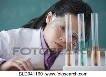 Stock Photography - asian female scientist 
looking at vials. 
fotosearch - search 
stock photos, 
pictures, images, 
and photo clipart