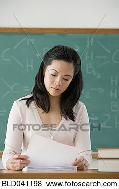 Stock Photo - asian female teacher 
reading papers. 
fotosearch - search 
stock photos, 
pictures, images, 
and photo clipart