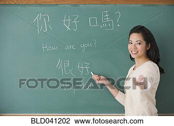 Stock Photo - asian female teacher 
writing chinese 
on blackboard. 
fotosearch - search 
stock photos, 
pictures, images, 
and photo clipart