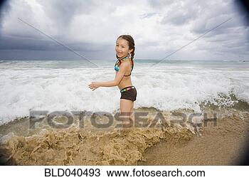 Stock Photo - asian girl playing 
in surf. fotosearch 
- search stock 
photos, pictures, 
images, and photo 
clipart