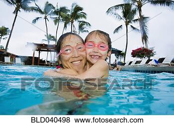 Stock Photo - asian mother and 
daughter hugging 
in swimming pool. 
fotosearch - search 
stock photos, 
pictures, images, 
and photo clipart