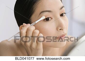 Picture - asian woman applying 
eye shadow. fotosearch 
- search stock 
photos, pictures, 
images, and photo 
clipart