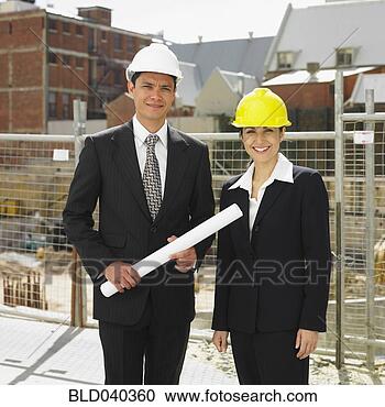 Stock Photography - businesspeople 
wearing hard hats 
at construction 
site. fotosearch 
- search stock 
photos, pictures, 
images, and photo 
clipart
