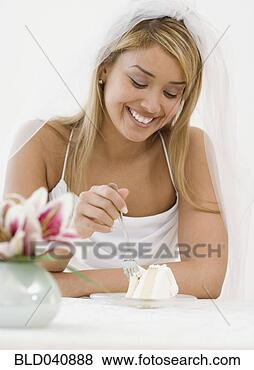 Stock Photo - hispanic bride 
eating cake. fotosearch 
- search stock 
photos, pictures, 
images, and photo 
clipart