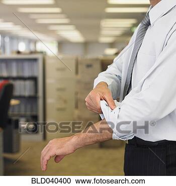 Stock Photography - hispanic businessman 
rolling up sleeve. 
fotosearch - search 
stock photos, 
pictures, images, 
and photo clipart