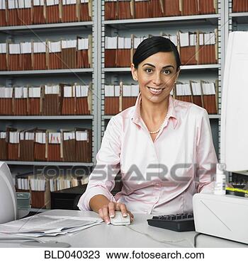 Stock Photo - hispanic businesswoman 
at computer. fotosearch 
- search stock 
photos, pictures, 
images, and photo 
clipart