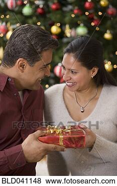 Stock Photo - hispanic couple 
exchanging gift. 
fotosearch - search 
stock photos, 
pictures, images, 
and photo clipart