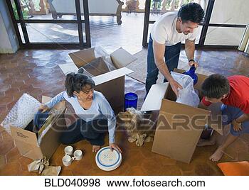 Stock Photo - hispanic family 
unpacking moving 
boxes. fotosearch 
- search stock 
photos, pictures, 
images, and photo 
clipart